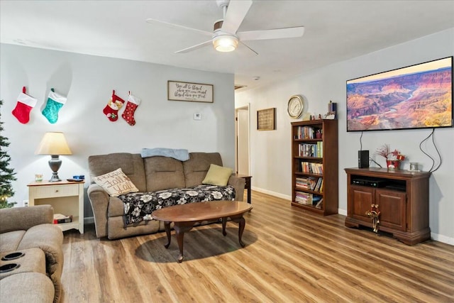 living room with hardwood / wood-style floors and ceiling fan