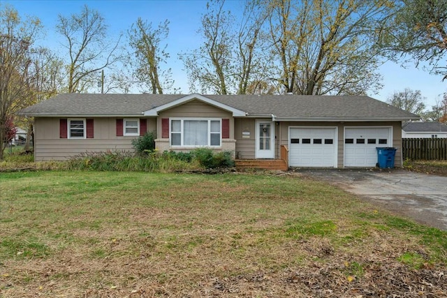 ranch-style house featuring a garage and a front lawn