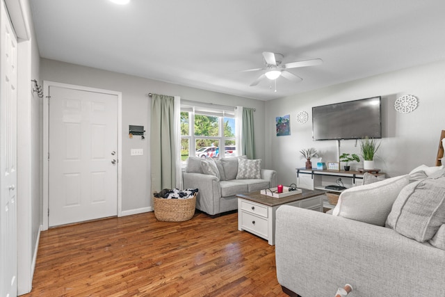 living room with hardwood / wood-style floors and ceiling fan