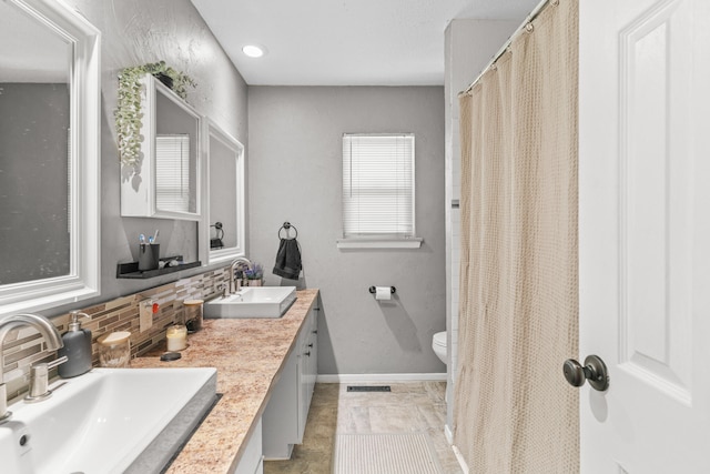 bathroom featuring tile patterned flooring, decorative backsplash, toilet, and vanity