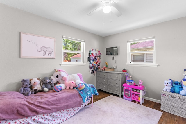 bedroom with dark hardwood / wood-style floors and ceiling fan