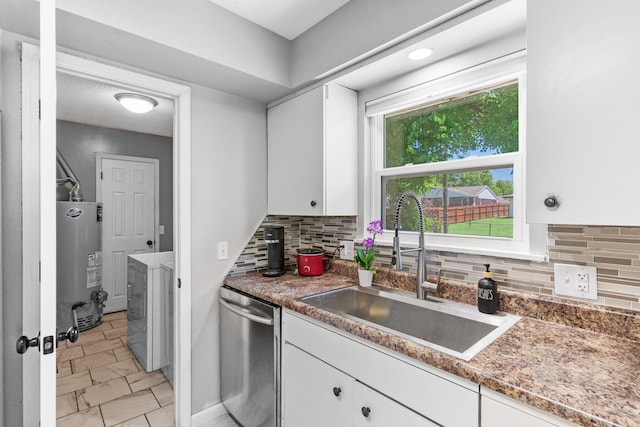 kitchen featuring stainless steel dishwasher, white cabinetry, and sink