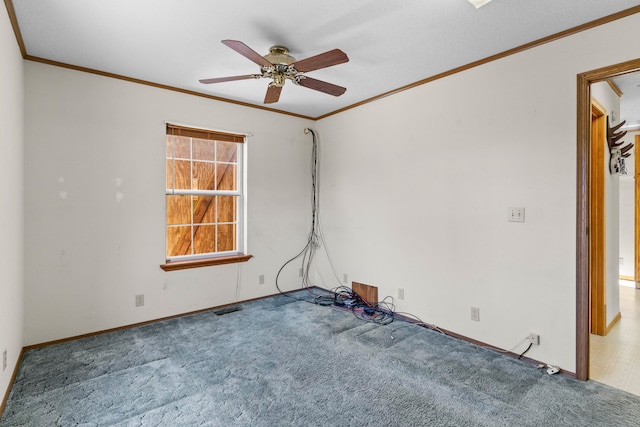 spare room with carpet, ceiling fan, and crown molding