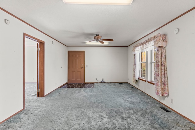 empty room with ceiling fan, crown molding, carpet floors, and a textured ceiling