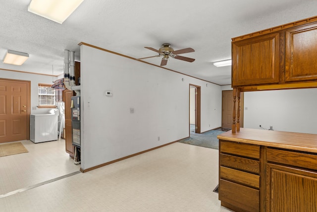 kitchen with washer / clothes dryer, ceiling fan, and a textured ceiling