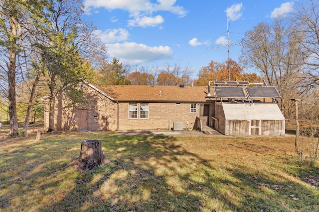 back of property with a lawn and central air condition unit