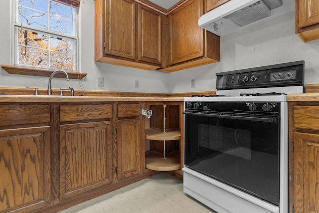 kitchen with white range with gas stovetop and sink