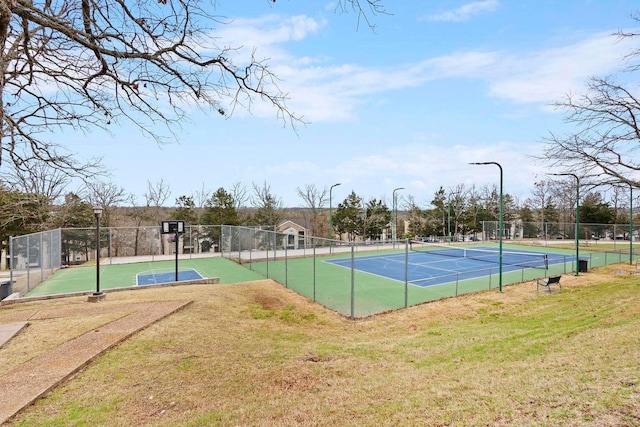 view of sport court with a yard and basketball hoop