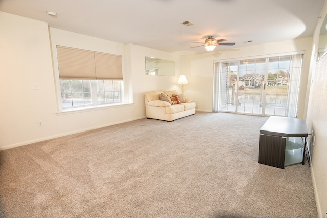 unfurnished room with carpet and ceiling fan