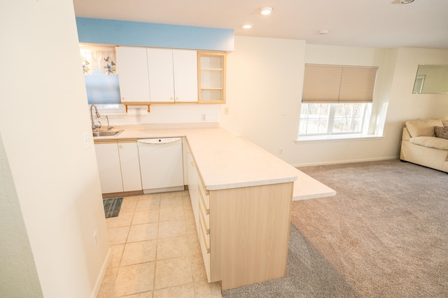 kitchen featuring kitchen peninsula, light carpet, dishwasher, and sink