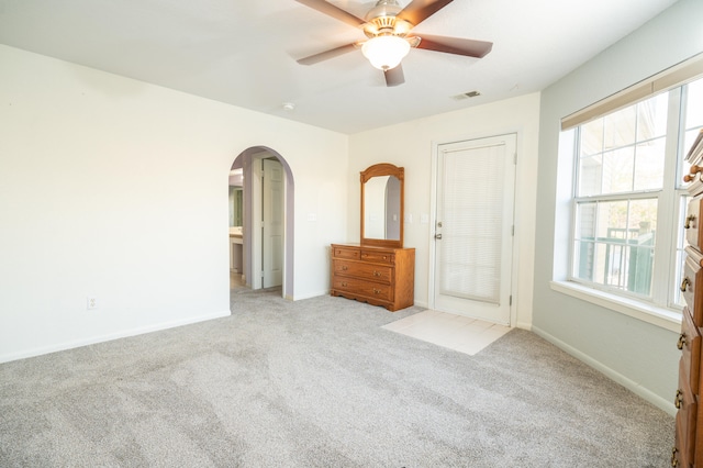 unfurnished bedroom featuring light carpet and ceiling fan