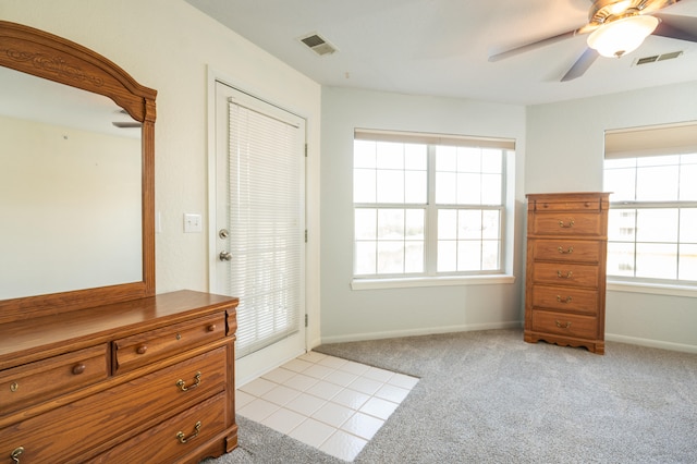 doorway with light carpet, ceiling fan, and a healthy amount of sunlight