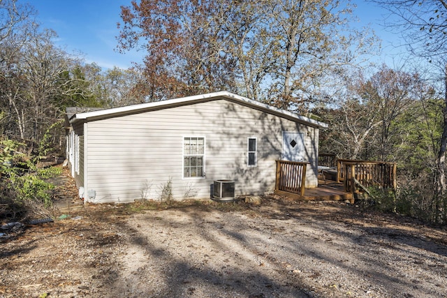 rear view of property featuring a wooden deck