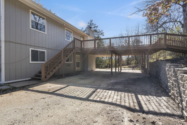 view of side of home featuring a deck and a carport