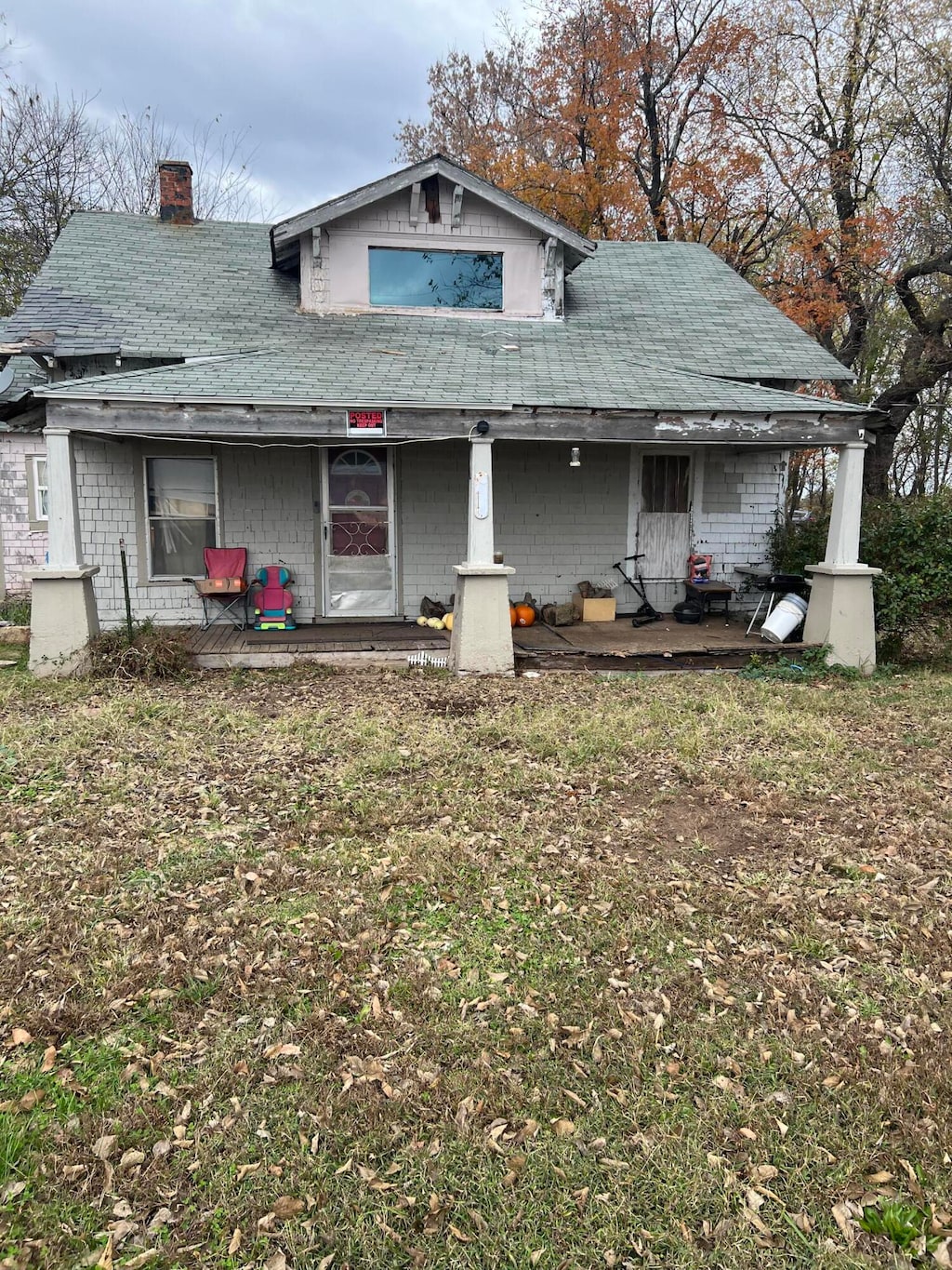 rear view of property with covered porch