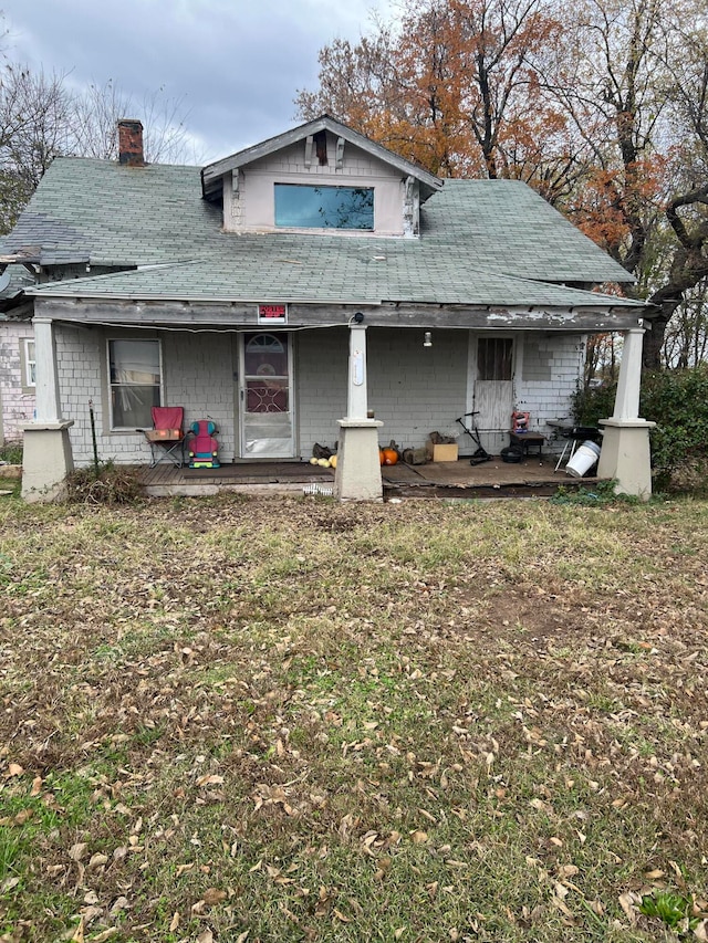 rear view of property with covered porch