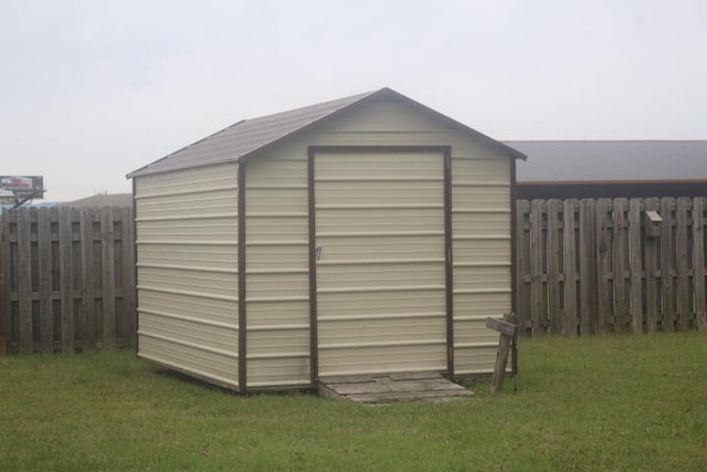 view of outdoor structure featuring a lawn