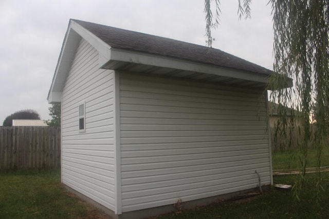 view of side of home featuring a storage unit