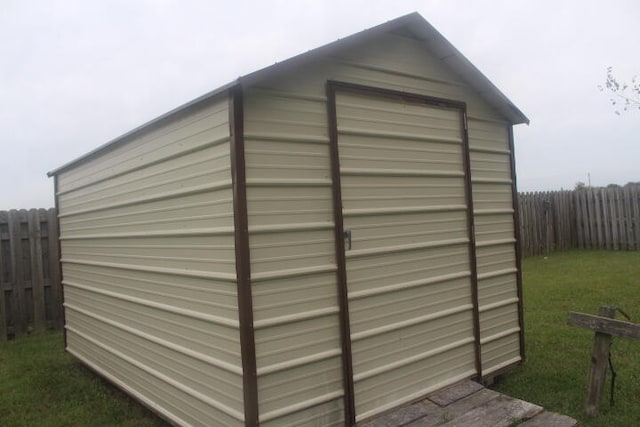 view of outbuilding with a yard