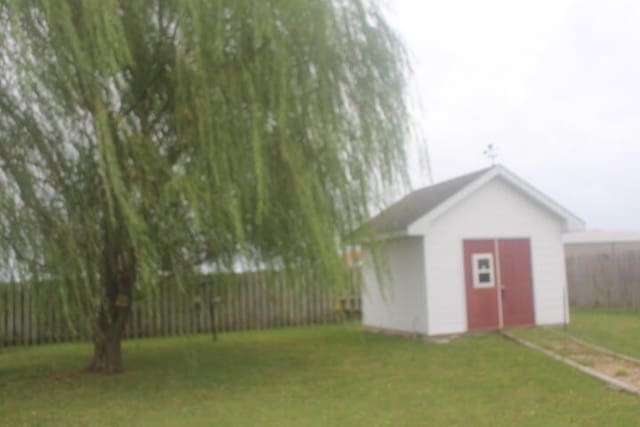 view of outdoor structure featuring a lawn