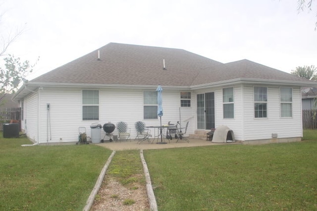 back of house with central AC unit, a patio area, and a yard