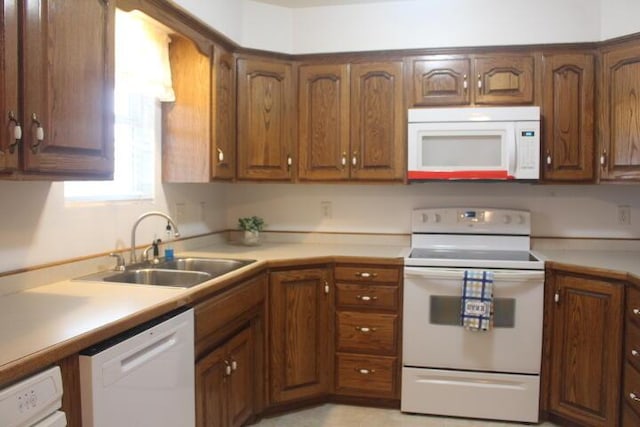 kitchen featuring sink and white appliances