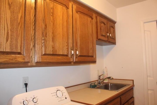 washroom featuring sink, cabinets, and washer / dryer