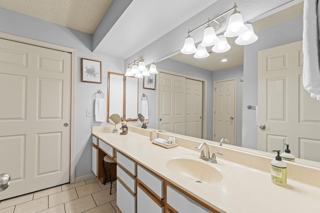 bathroom featuring vanity, an inviting chandelier, and tile patterned floors