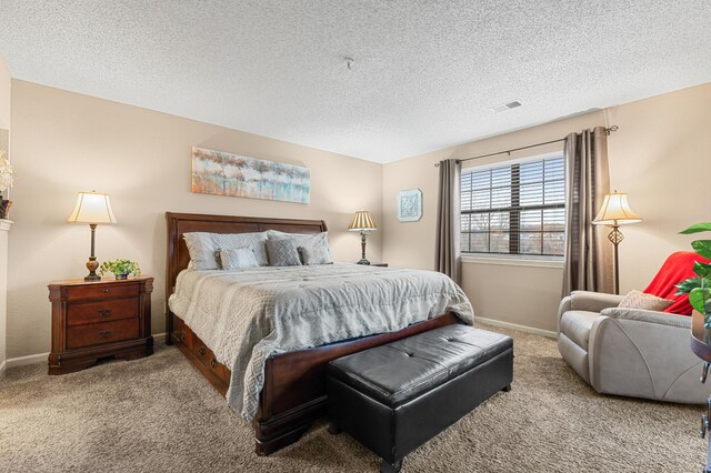 carpeted bedroom featuring a textured ceiling