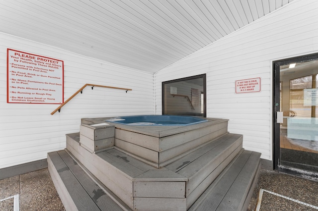 interior space with a jacuzzi, wooden ceiling, and vaulted ceiling