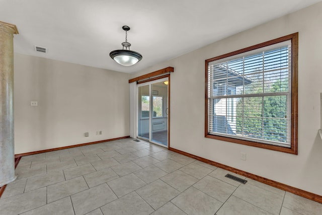 tiled spare room with a wealth of natural light