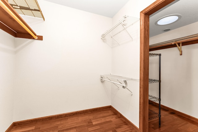 walk in closet with hardwood / wood-style floors