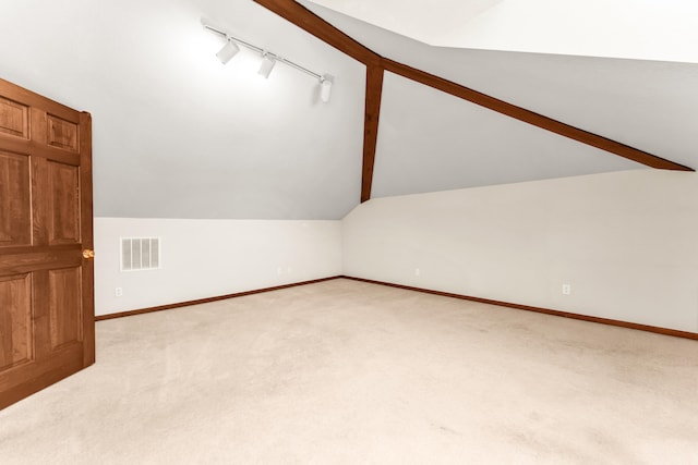 bonus room featuring light colored carpet and lofted ceiling