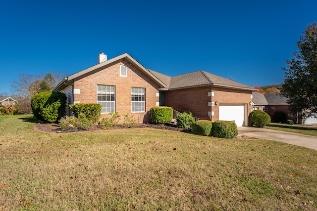 view of front of home with a front yard and a garage