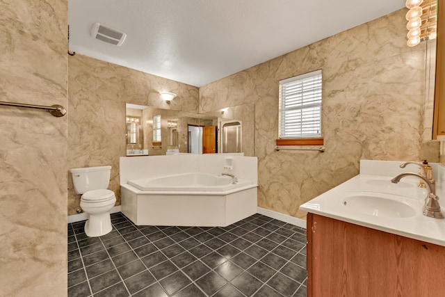 bathroom featuring a bath, vanity, toilet, and tile patterned floors