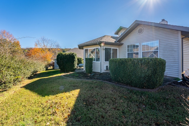 exterior space featuring a lawn and a sunroom