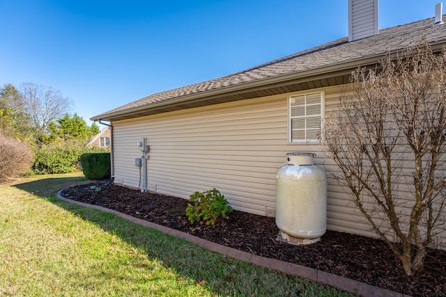 view of side of home featuring a lawn