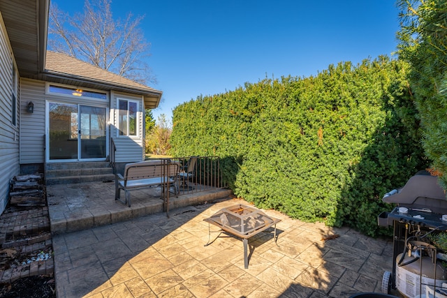 view of patio / terrace featuring an outdoor fire pit