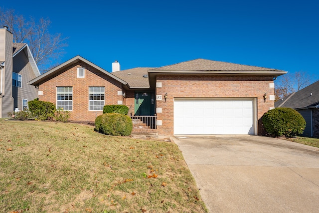 view of front of house with a garage and a front yard