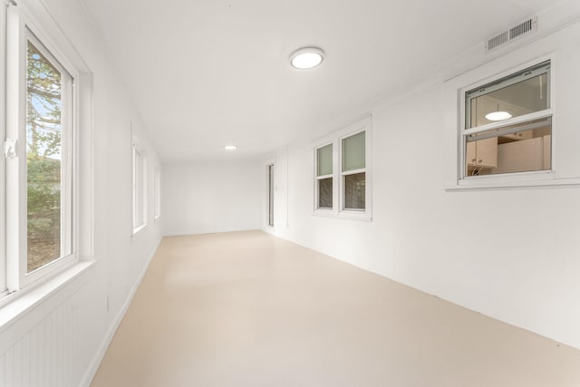 spare room with plenty of natural light and crown molding