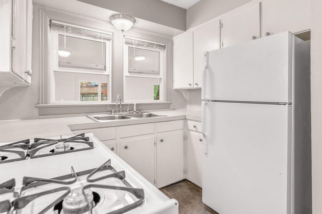 kitchen featuring tile patterned floors, sink, white cabinets, and white appliances