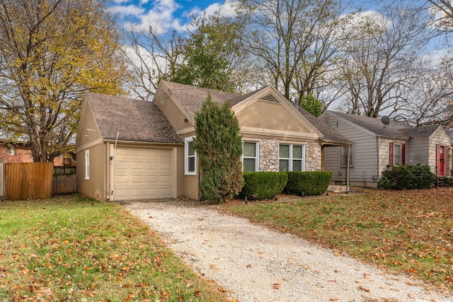 view of front of house featuring a garage and a front lawn