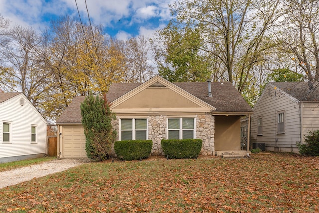 view of front of home with central AC unit and a garage