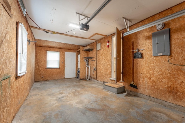 garage with an AC wall unit, electric panel, and a garage door opener