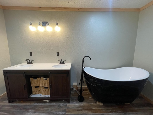 bathroom featuring hardwood / wood-style flooring, a washtub, and vanity