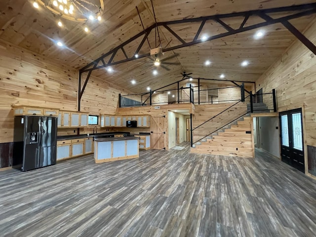 kitchen with hardwood / wood-style floors, a center island, high vaulted ceiling, black appliances, and beamed ceiling