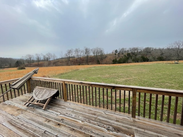 deck featuring a yard and a rural view