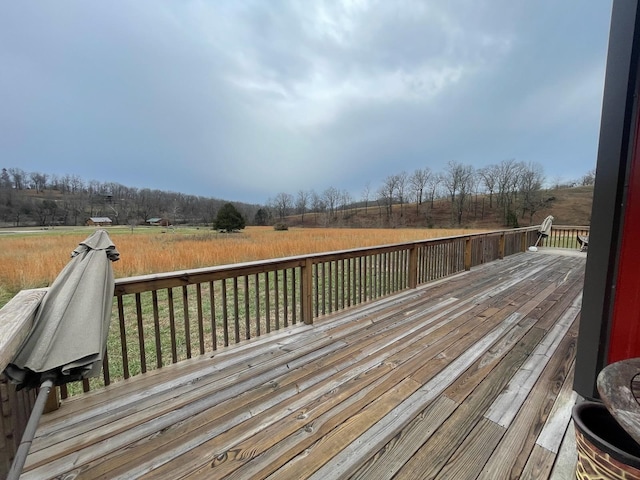 wooden deck with a rural view