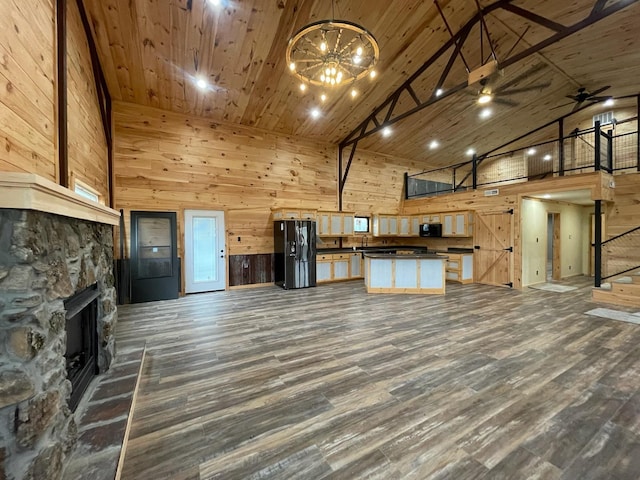 kitchen featuring a fireplace, dark hardwood / wood-style floors, high vaulted ceiling, and black appliances