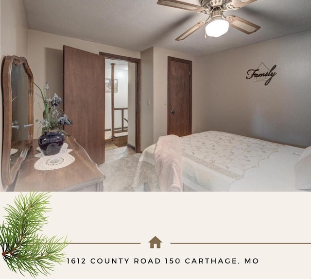 bedroom featuring ceiling fan and carpet